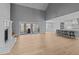Spacious living room with hardwood floors, fireplace, and open layout with seamless flow to the kitchen at 290 Whistlers Cv, Louisburg, NC 27549