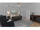 Spacious bedroom with tray ceiling, sitting area, and abundant natural light at 290 Whistlers Cv, Louisburg, NC 27549
