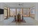 Cozy sunroom featuring a barrel table, seating, and panoramic views of the surrounding nature at 290 Whistlers Cv, Louisburg, NC 27549