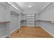 Spacious walk-in closet with custom shelving and ample storage space at 290 Whistlers Cv, Louisburg, NC 27549