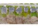 A serene aerial view of a neighborhood showcasing well-manicured lawns, backyard retreat with hot tub and screened porch at 307 Sugarberry Ln, Clayton, NC 27527