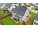 Aerial view of fenced backyard, featuring a hot tub and screened porch for relaxing and entertaining outdoors at 307 Sugarberry Ln, Clayton, NC 27527