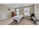 Bright bedroom features two windows, a keyboard, and neutral-toned furnishings at 307 Sugarberry Ln, Clayton, NC 27527