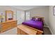 Inviting bedroom features pine furniture, plush purple bedding, and ample natural light at 307 Sugarberry Ln, Clayton, NC 27527