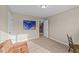 Neutral bedroom featuring beige walls and carpet, complemented by bright turtle artwork at 307 Sugarberry Ln, Clayton, NC 27527