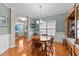 Cozy dining area with a round wooden table, seating for four, a chandelier, and hardwood floors at 307 Sugarberry Ln, Clayton, NC 27527