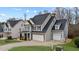 Charming two-story home with a well-manicured lawn, gray siding, and a two-car garage at 307 Sugarberry Ln, Clayton, NC 27527
