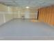 Spacious garage with finished walls, gray epoxy floor and a utility sink provides ample storage and workspace at 307 Sugarberry Ln, Clayton, NC 27527
