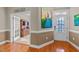 Hallway with hardwood floors, wall art, and a doorway leading to another room at 307 Sugarberry Ln, Clayton, NC 27527