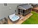 A hot tub and screened porch, perfect for outdoor relaxation, make for a delightful backyard retreat at 307 Sugarberry Ln, Clayton, NC 27527