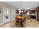 Eat-in kitchen featuring a breakfast table, tiled floors, and French doors to the backyard at 307 Sugarberry Ln, Clayton, NC 27527