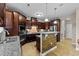 Open kitchen featuring tiled floors, a breakfast bar, and stainless steel appliances at 307 Sugarberry Ln, Clayton, NC 27527