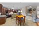 Eat-in kitchen featuring warm wood cabinetry, tiled floors, and granite countertops at 307 Sugarberry Ln, Clayton, NC 27527