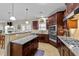 Open kitchen featuring granite countertops, stainless steel appliances, and dark wood cabinets at 307 Sugarberry Ln, Clayton, NC 27527