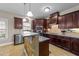 Open kitchen featuring tiled floors, stainless steel appliances, and a breakfast bar at 307 Sugarberry Ln, Clayton, NC 27527