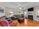 Comfortable living room featuring a cozy fireplace, plush sofas, and natural light at 307 Sugarberry Ln, Clayton, NC 27527