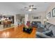 Open-concept living area featuring hardwood floors, comfortable seating, and a view of the dining area at 307 Sugarberry Ln, Clayton, NC 27527