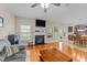 Inviting living room featuring hardwood floors, fireplace, and abundant natural light at 307 Sugarberry Ln, Clayton, NC 27527