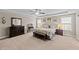 Expansive main bedroom with tray ceiling, seating, and lots of natural light at 307 Sugarberry Ln, Clayton, NC 27527