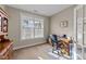 Bright office space featuring a large window, neutral walls, and classic wooden desk with an office chair at 307 Sugarberry Ln, Clayton, NC 27527