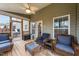 Cozy screened porch with wicker furniture and cushions, perfect for relaxing at 307 Sugarberry Ln, Clayton, NC 27527