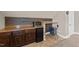 Close up of wet bar in bonus room, featuring a mini-fridge and stool at 307 Sugarberry Ln, Clayton, NC 27527