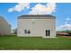 The backyard has a sliding glass door, a concrete patio, and is filled with grass at 31 Red Cedar Way, Fuquay Varina, NC 27526