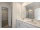 Bathroom with dual vanities, framed mirror, and a shower with glass doors at 31 Red Cedar Way, Fuquay Varina, NC 27526