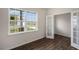 Bedroom featuring hardwood floors, ample natural light, and an open doorway with glass doors at 31 Red Cedar Way, Fuquay Varina, NC 27526