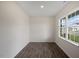 Bedroom features dark hardwood floors, neutral walls, and a large window at 31 Red Cedar Way, Fuquay Varina, NC 27526