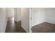 Hallway view featuring hardwood floors throughout, and white base-molding at 31 Red Cedar Way, Fuquay Varina, NC 27526