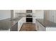 Bright kitchen with stainless steel appliances, granite countertops, island, and hardwood floors at 31 Red Cedar Way, Fuquay Varina, NC 27526