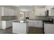Bright kitchen features white cabinets, stainless steel appliances, granite counters and island at 31 Red Cedar Way, Fuquay Varina, NC 27526