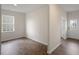 Bright living room features hardwood floors, fresh paint, and a front door with glass window at 31 Red Cedar Way, Fuquay Varina, NC 27526