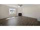 Spacious living room with fireplace, large windows, and a ceiling fan at 31 Red Cedar Way, Fuquay Varina, NC 27526
