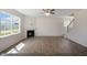 Open-concept living room features a fireplace, large windows, and access to the staircase at 31 Red Cedar Way, Fuquay Varina, NC 27526