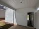 Covered porch that has white siding and a doorway leading into the attached garage at 316 White Oak Garden Way # 217, Garner, NC 27529