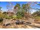 Backyard oasis with stone patio, two chairs, and a unique fire pit centerpiece at 3324 Thomas Rd, Raleigh, NC 27607