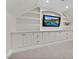 Finished basement area featuring built-in cabinets and shelving with a modern television at 3324 Thomas Rd, Raleigh, NC 27607