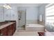 En suite bathroom features a large soaking tub and glass walk-in shower with a granite countertop vanity at 3324 Thomas Rd, Raleigh, NC 27607