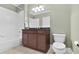 Well-maintained bathroom with granite countertops, cabinets, tub, and toilet offers convenience at 3324 Thomas Rd, Raleigh, NC 27607
