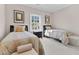 Bright bedroom with twin beds, natural light from the window, and decorative wall art at 3324 Thomas Rd, Raleigh, NC 27607