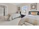 Bright bedroom featuring twin beds, a window view, and stylish decor, ideal for a guest or room at 3324 Thomas Rd, Raleigh, NC 27607