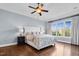 Spacious primary bedroom features a large bed, hardwood floors, large windows, and neutral paint at 3324 Thomas Rd, Raleigh, NC 27607