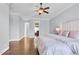Spacious primary bedroom features a large bed, hardwood floors, large windows, and neutral paint at 3324 Thomas Rd, Raleigh, NC 27607