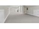 Spacious bonus room featuring neutral carpeting, built-in shelving, and a functional desk area for work or hobbies at 3324 Thomas Rd, Raleigh, NC 27607