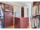 Large closet features ample storage with custom shelving and drawers to organize all of your belongings at 3324 Thomas Rd, Raleigh, NC 27607