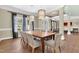 Well-lit dining room features a large table, stylish chairs, and scenic windows at 3324 Thomas Rd, Raleigh, NC 27607