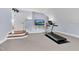 Bright home gym equipped with a treadmill and TV, situated in a well-lit room for workouts at 3324 Thomas Rd, Raleigh, NC 27607