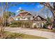 Beautiful two-story home with a brick and siding exterior and a well-manicured front yard with mature trees at 3324 Thomas Rd, Raleigh, NC 27607